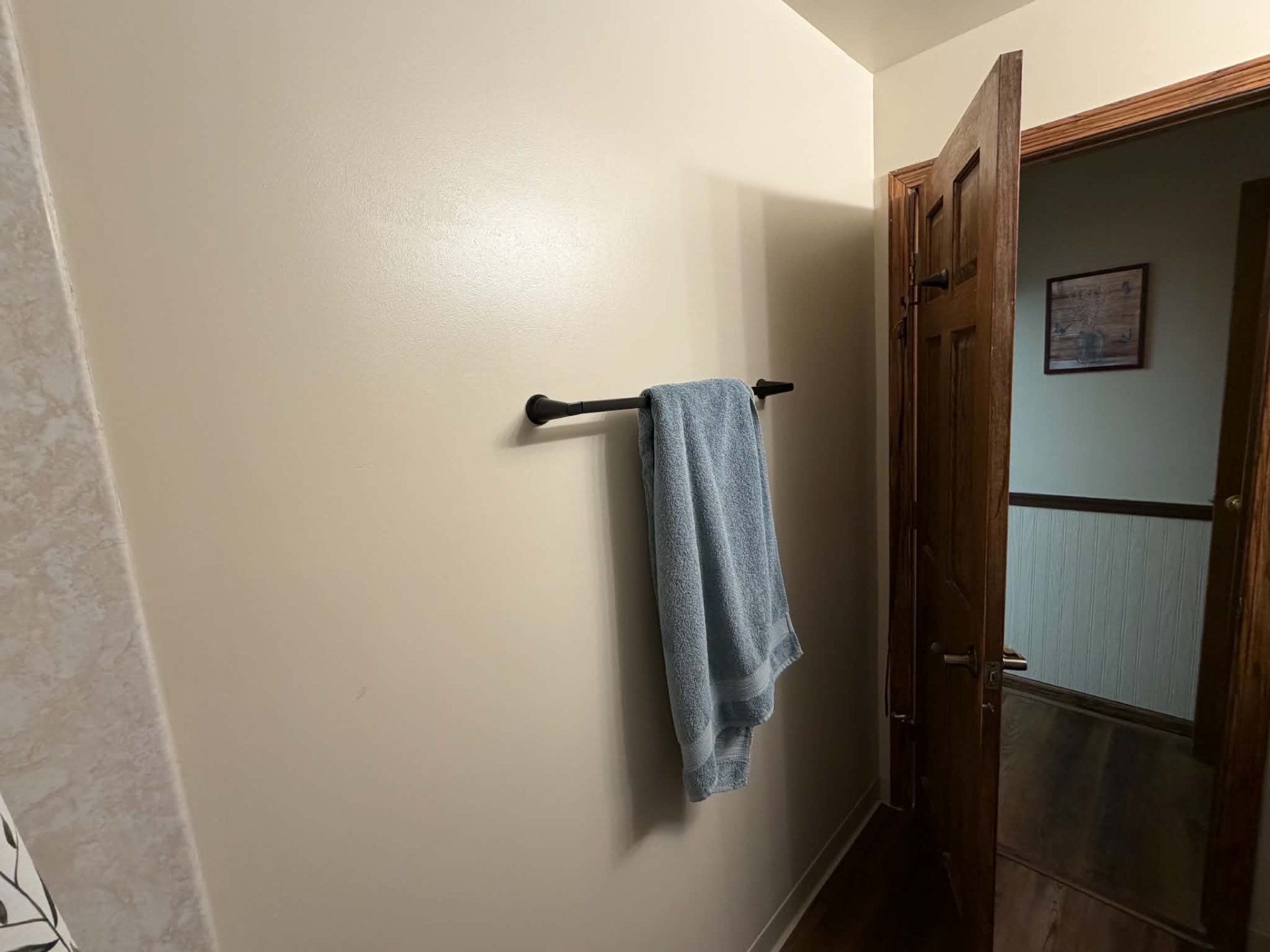 Finished bathroom wall and towel rail